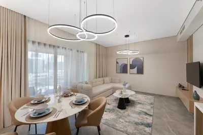 a living room with a table and a couch at Brand New 2BR Peninsula One with Burj Khalifa View in Dubai