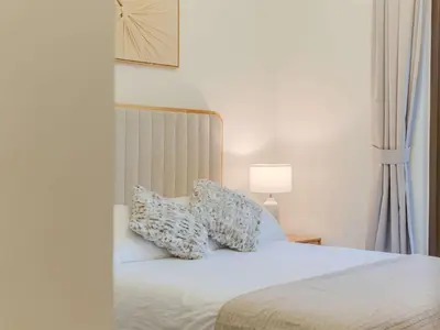a bedroom with a bed with two pillows on it at Luxury Dubai Creek Beach with Private Lagoon in Dubai