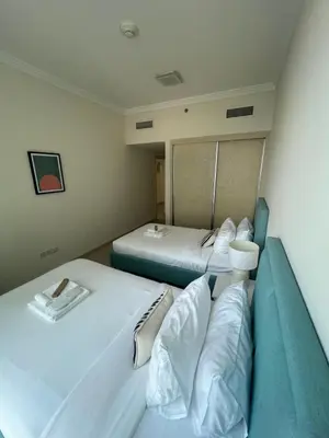 a room with two beds in a hospital room at 1st Row Beach Views with Private Beach and Resort Vibes in Dubai