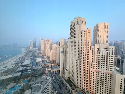 an aerial view of a city with tall buildings at Beachfront Luxury Penthouse at The Walk JBR next to Bluewaters Island - 2BR & Maids Room in Dubai