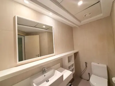 a bathroom with a sink and a mirror and a toilet at Beachfront Luxury Penthouse at The Walk JBR next to Bluewaters Island - 2BR & Maids Room in Dubai