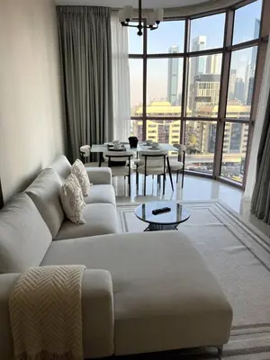a living room with a couch and tables and a large window at Amazing 1BR Full Burj View in Dubai