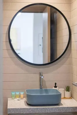 a bathroom with a blue sink and a mirror at StayMada - Peninsula Panoramic Waterfront Views in Dubai