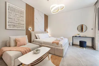 a living room with a bed and a couch at Canal Walk Luxury Studio Central Business Bay in Dubai