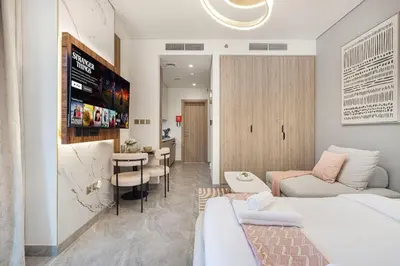 a living room with a bed and a dining room at Canal Walk Luxury Studio Central Business Bay in Dubai