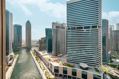 a view of a river in a city with tall buildings at Canal Walk Luxury Studio Central Business Bay in Dubai