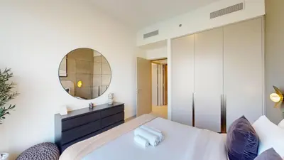 a bedroom with a bed and a mirror at Vacationer l Fountain, Burj Khalifa View l 2 Bedroom l Downtown Dubai in Dubai