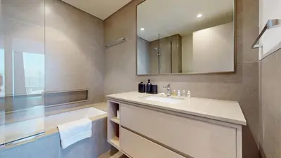 a bathroom with a sink and a mirror at Vacationer l Fountain, Burj Khalifa View l 2 Bedroom l Downtown Dubai in Dubai