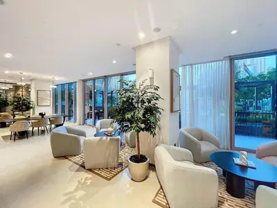 a living room with chairs and a potted plant at Vacationer l Fountain, Burj Khalifa View l 2 Bedroom l Downtown Dubai in Dubai