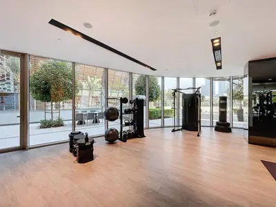 a gym with a bunch of equipment in a room with windows at Vacationer l Fountain, Burj Khalifa View l 2 Bedroom l Downtown Dubai in Dubai