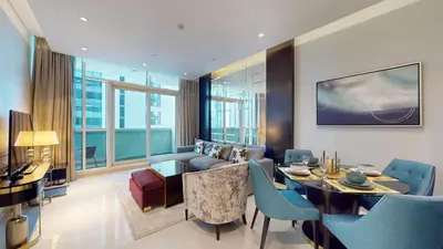 a living room with a couch and a table at Vacationer l Stylish 1 Bedroom l Downtown Dubai l Pool, Gym Access in Dubai