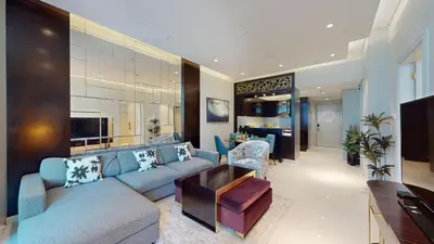 a large living room with a blue couch and chairs at Vacationer l Stylish 1 Bedroom l Downtown Dubai l Pool, Gym Access in Dubai