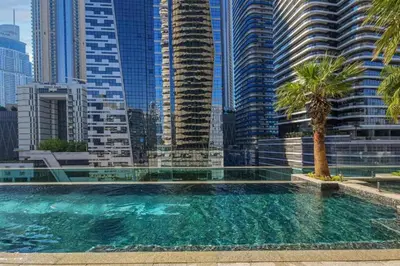 a swimming pool in a city with tall buildings at Vacationer l Stylish 1 Bedroom l Downtown Dubai l Pool, Gym Access in Dubai