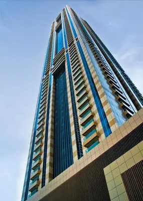 a tall building with a blue sky in the background at Accommodation for girls only in Dubai