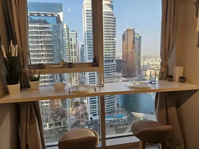 a room with a view of a city from a window at JLT Studio, Steps to Metro, High floor, Smart Home in Dubai