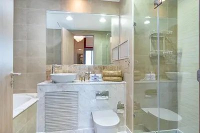 a bathroom with a sink and a toilet and a mirror at Exquisite Marina Home with Panoramic Yacht Views in Dubai