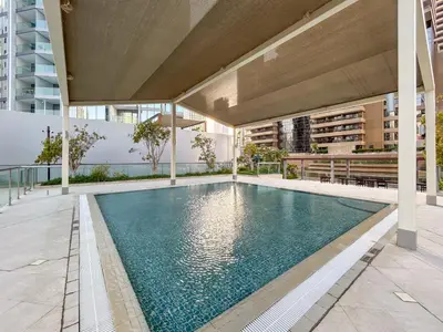 a swimming pool in the middle of a building at Exquisite Marina Home with Panoramic Yacht Views in Dubai