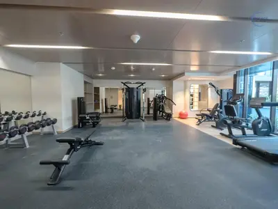 a gym with several treadmills and cardio machines at Modern Retreat at Azizi Azure, Meydan in Dubai