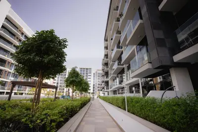 a walkway in the middle of an apartment building at Azizi Modern Studio 10 min to Downtown in Dubai