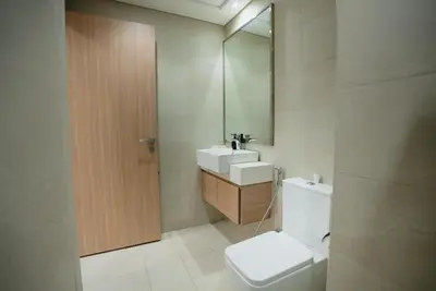 a bathroom with a toilet and a sink and a mirror at Azizi Modern Studio 10 min to Downtown in Dubai