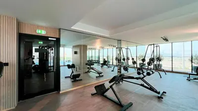 a gym with cardio equipment in a building at Elegant 1BR Stay in Binghatti Heights JVC in Dubai
