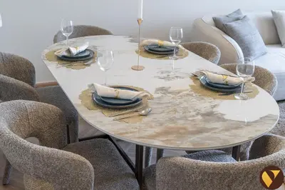 a white table with glasses and plates and chairs at Vogue JVC Jeewar Tower near Circle Mall, Two Bedroom Apartment with Balcony and City View, Access to all Amenities in Dubai