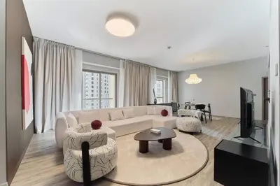 a living room with a couch and a table at FAM Living - 1 Bedroom in Rimal 2 Dubai Marina in Dubai