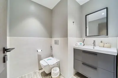 a bathroom with a toilet and a sink and a mirror at FAM Living - 1 Bedroom in Rimal 2 Dubai Marina in Dubai