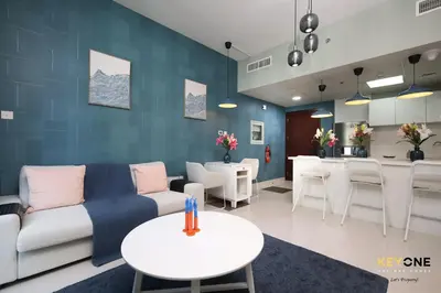 a living room with a couch and a table at Serene Beachside Two-Bedroom Retreat in Dubai
