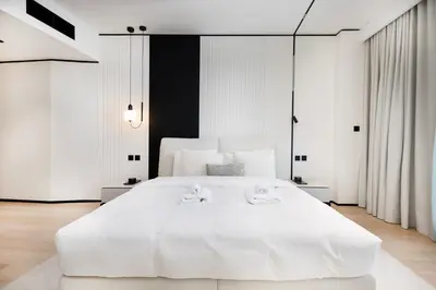 a bedroom with a large white bed with two towels on it at Opera Grand Sky Luxurious 3-Bedroom Apartment in Downtown Dubai with Panoramic Burj Khalifa View in Dubai