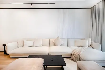 a living room with a white couch and a table at Opera Grand Sky Luxurious 3-Bedroom Apartment in Downtown Dubai with Panoramic Burj Khalifa View in Dubai