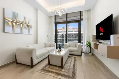 a living room with two white couches and a tv at Bright Designer Stay in Luxurious Comfort in Dubai