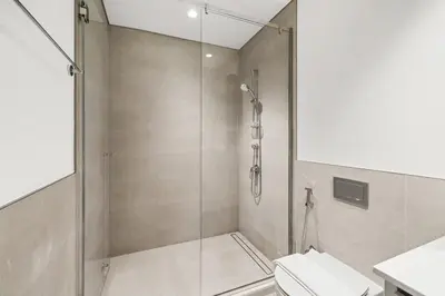 a bathroom with a shower and a toilet at Creek Beach Sunset 3! Lagoon Access! in Dubai