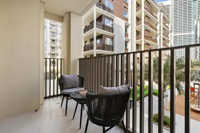 a balcony with chairs and a table on a balcony at Creek Beach Sunset 3! Lagoon Access! in Dubai