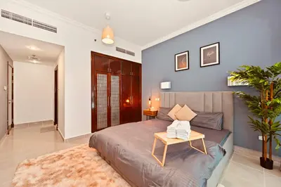 a bedroom with a bed with a table on it at Luxury Retreat Your High Floor Heaven in Marina in Dubai