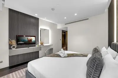 a bedroom with two beds and a flat screen tv at Lavish Marina Gem - Dubai Eye Views - Infinity Pool in Dubai