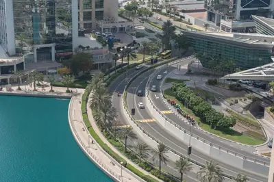 an aerial view of a city with a road and water at StayShort - Sophisticated unit in JLT Sleeps 6 with Lake Views in Dubai