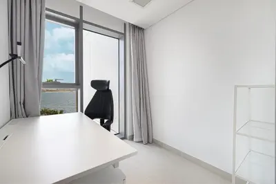 a white room with a desk and a window at 2 Bedroom Bluewaters Retreat with Office and Pool Views in Dubai