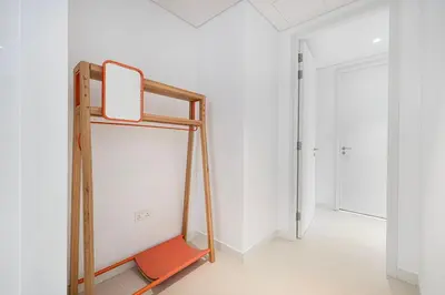a ladder in a room with a white wall at 2 Bedroom Bluewaters Retreat with Office and Pool Views in Dubai