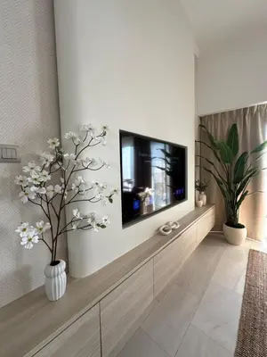a living room with a flat screen tv on a wall at Stunning 1-Bedroom Apartment , Full Marina View in Dubai
