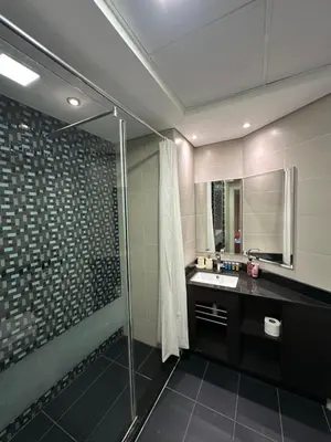 a bathroom with a glass shower and a sink at Stunning 1-Bedroom Apartment , Full Marina View in Dubai