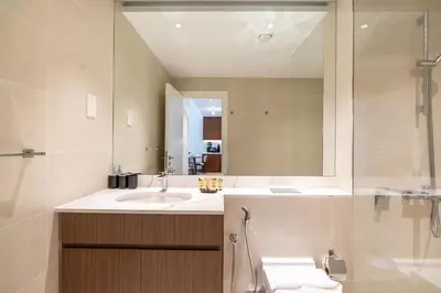 a bathroom with a sink and a mirror at PVH - Breezy 1BR with Partial Sea View - La Sirene in Dubai