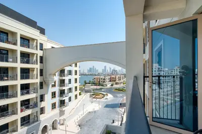 an apartment balcony with a view of the water at PVH - Breezy 1BR with Partial Sea View - La Sirene in Dubai