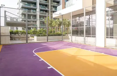 a court in a building with a tennis court at Stylish Dubai Hills Studio with Rooftop Pool and Gym in Dubai