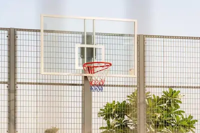 a basketball hoop in a cage with plants at Stylish Dubai Hills Studio with Rooftop Pool and Gym in Dubai