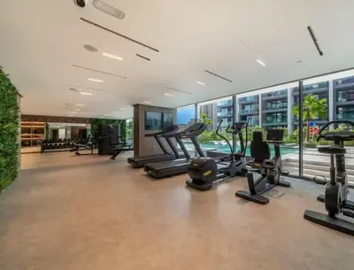a gym with cardio equipment in a building at Stylish Dubai Hills Studio with Rooftop Pool and Gym in Dubai