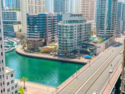 a bridge over a river in a city with buildings at Chic Stay in Sparkle Towers in Dubai