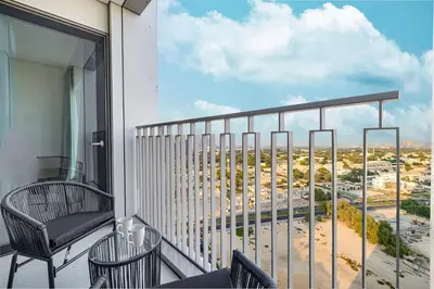a balcony with chairs and a view of a city at Luxury 2BR Downtown Dubai Near Dubai Mall in Dubai