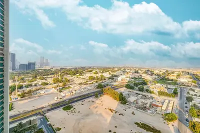 an aerial view of a city with a tall building at Luxury 2BR Downtown Dubai Near Dubai Mall in Dubai