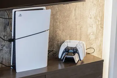 a video game controller sitting on a counter next to a refrigerator at Luxury 2BR Downtown Dubai Near Dubai Mall in Dubai